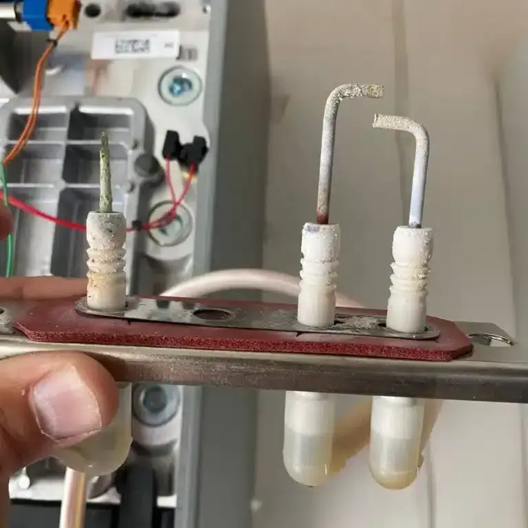 Oxidised spark electrodes from the boiler, held in an engineer’s hand