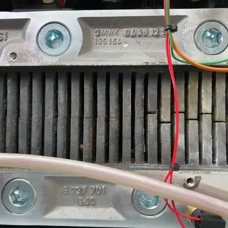 The boiler’s heat exchanger, with deposits between its fins