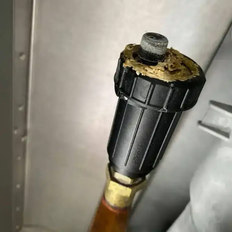 A boiler component encrusted with limescale, removed during the service