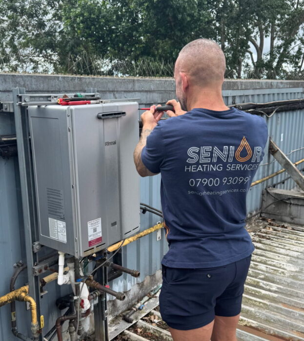 Senior Heating Services engineer installing a Rinnai continuous flow gas water heater